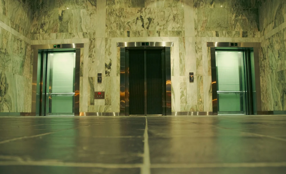 Lift lobby with tiled floor and lift doors